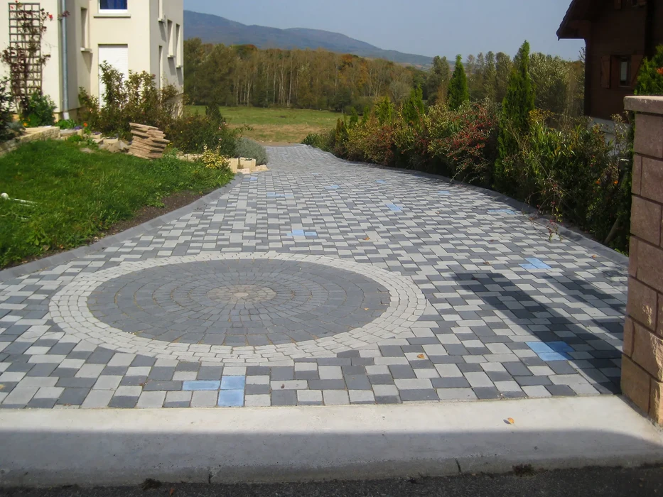 Espace extérieur avec pelouse verdoyante parfaitement entretenue bordant un chemin pavé